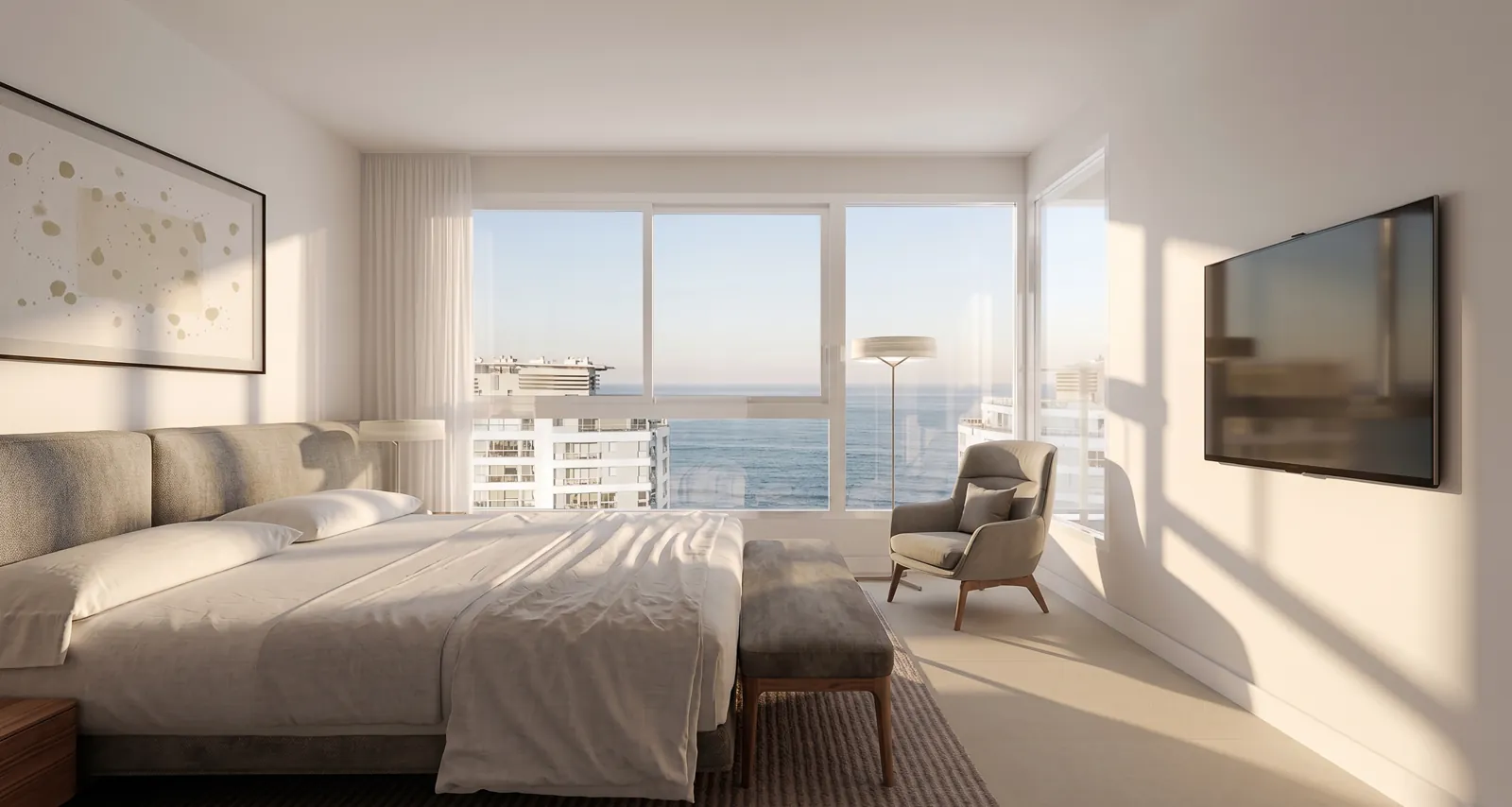 Dormitorio en suite de un apartamento de Torre 5, con vista al mar